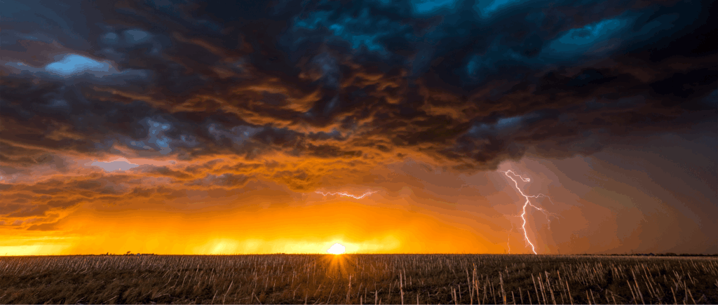 Thunderstorm with lightning rolling over sunlit plains